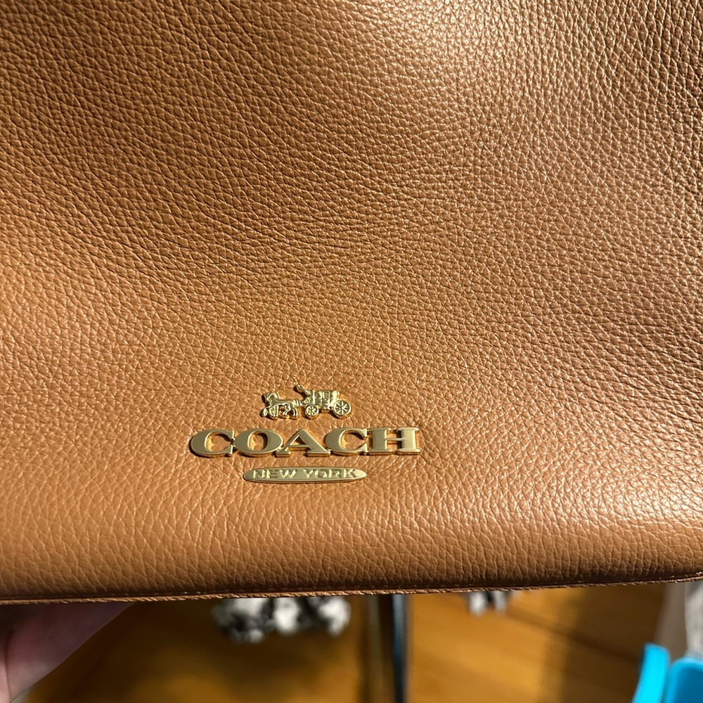 Tan leather shoulder purse from Coach.